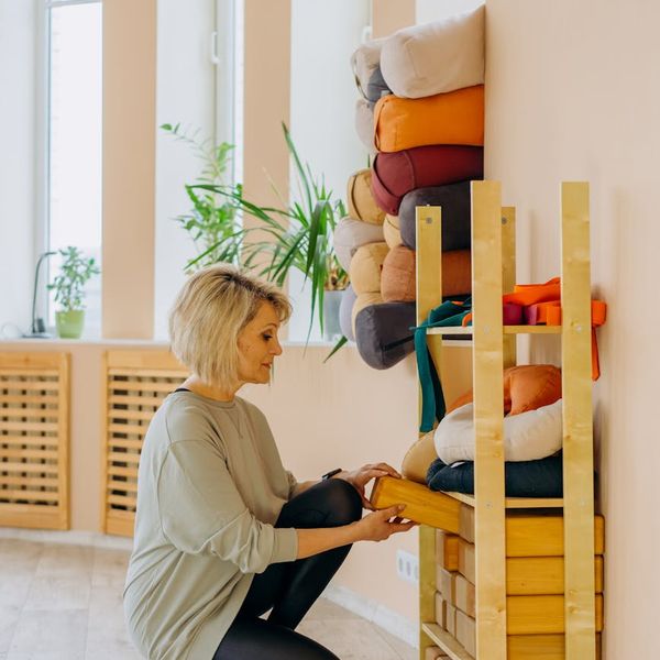Person meditating peacefully in a bright, modern studio.